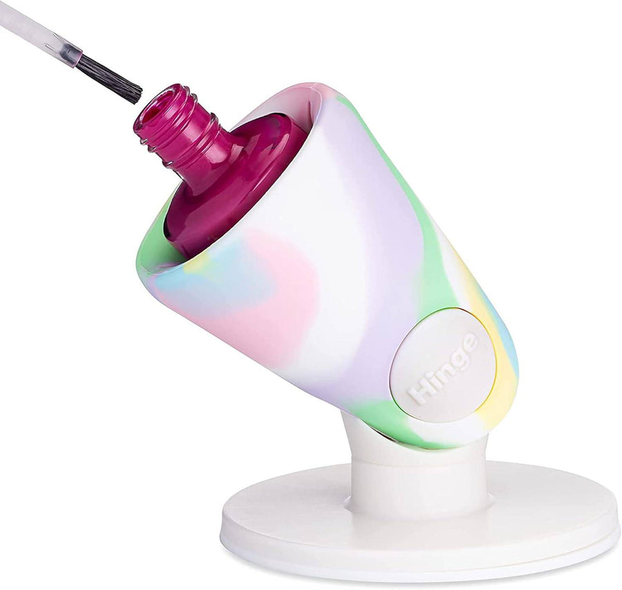 A tweexy Hinge on its round suction base, holding a polish bottle tilted forward